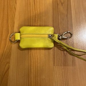 Roots coin purse with key attachment. Yellow.